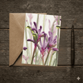Greeting card with floral design on a wooden surface